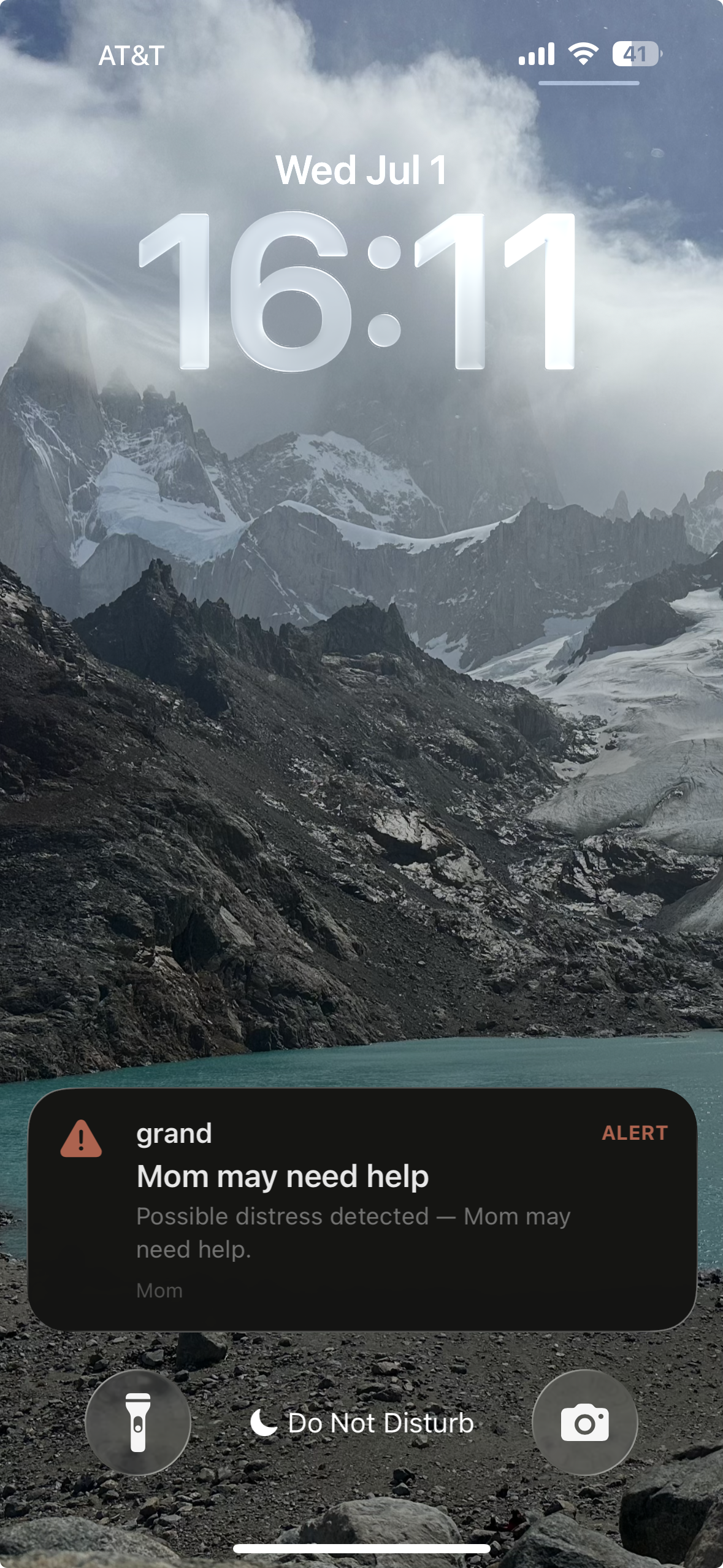 iPhone lock screen showing a Grand alert that Mom may need help.