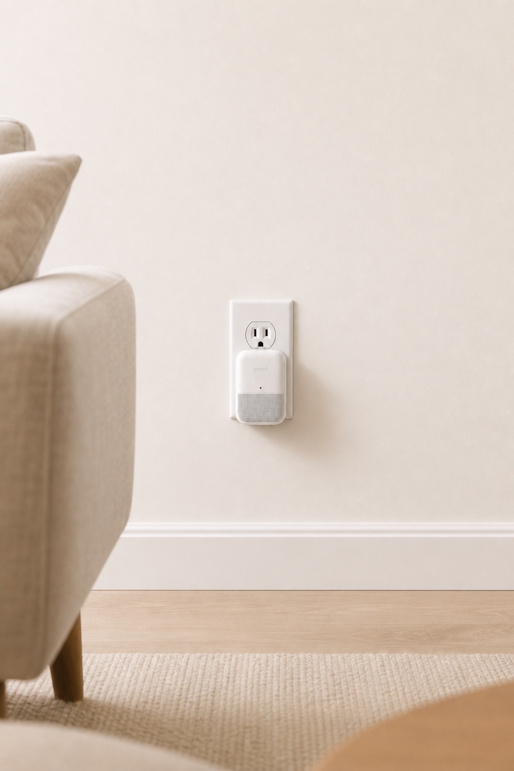 A Grand sensor plugged into a wall outlet at home.